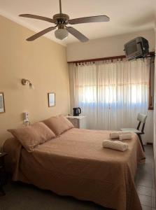 a bedroom with a large bed with a ceiling fan at La Cibeles in Miramar