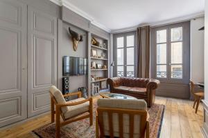 - un salon avec un canapé et des chaises dans l'établissement Curiosité - 2 chambres- proche Opéra, à Lyon