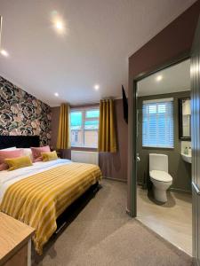 a bedroom with a large bed and a toilet at Luxury Lodge With Hot Tub In Royal Deeside in Strachan