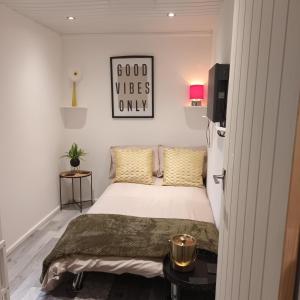 - une chambre avec un lit et un panneau indiquant une bonne ambiance uniquement dans l'établissement Le Hub - Roundhay Leeds - 1-Bed Studio Apartment, à Leeds