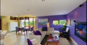 a living room with a couch and a dining room at Captiva Wexford - Your Ultimate Luxury Family Villa Getaway in Kilmuckridge +53 photos