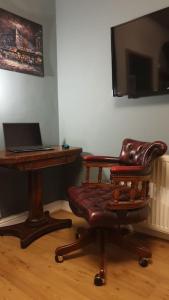 a room with a chair and a desk with a laptop at Entire house in Sherwood, Nottingham in Nottingham