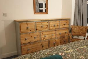 a dresser with a mirror on top of it at Entire house in Sherwood, Nottingham in Nottingham