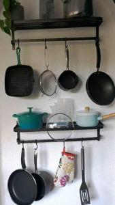 a shelf with pots and pans and utensils on it at Entire house in Sherwood, Nottingham in Nottingham