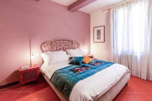 a bedroom with a large bed with a large window at Casa nel Centro Storico Firenze in Florence