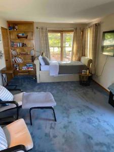 a living room with a bed and a couch at Lakeside resort home. Sunsets, fishing, paddling. in Avon Lake