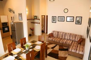 a living room with a couch and a table at Square One HEIGHTS- Kiribathgoda Kelaniya in Kiribathgoda