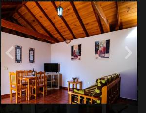 salon z kanapą i stołem z krzesłami w obiekcie Casa las toscas w mieście Calera