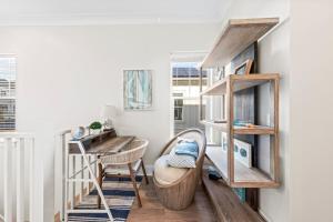a living room with a chair and a stair case at New 30A Inlet Beach House - Sleeps 14 - 10 beds in Rosemary Beach