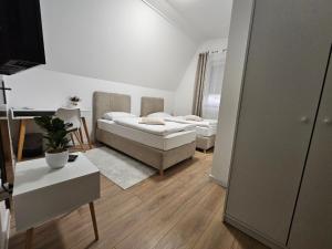 a living room with two beds and a table at Drava Osijek in Osijek