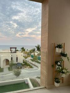 a view of the ocean from a balcony of a building at Sifah Ocean Breeze Villa in Muscat