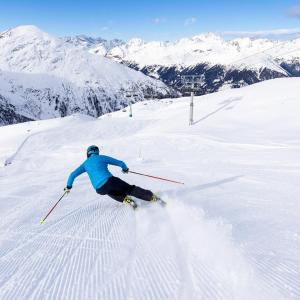 a person is skiing down a snow covered slope at FP Muehlmann&Schoen in Innervillgraten