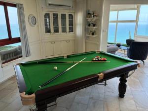 a living room with a pool table in a room at Sea-front apartment Netanya in Netanya