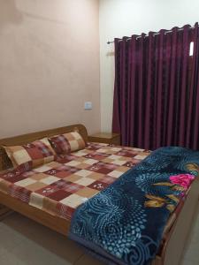 Bett mit einer Decke auf dem Zimmer in der Unterkunft Anant Paying Guest house in Ayodhya