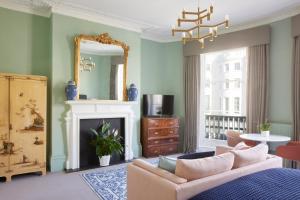 a living room with a couch and a mirror at Lansdowne House Hove in Brighton & Hove