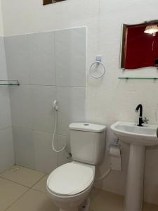 a bathroom with a toilet and a sink at Casa da Lagoa in Jijoca de Jericoacoara