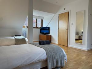 a hotel room with two beds and a television at The Corner House in Rochester