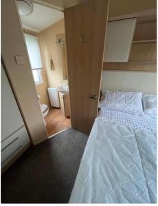 Postel nebo postele na pokoji v ubytování Spacious & welcoming 6th Berth Caravan California Cliffs Holiday Park, Norfolk Coast