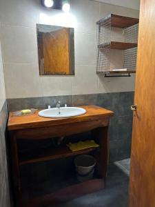 a bathroom with a sink and a mirror at Cabañas del Amanecer in Tanti