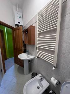 a bathroom with a sink and a toilet and a mirror at Bengiorne! Casa vacanza Al Viale in Raiano