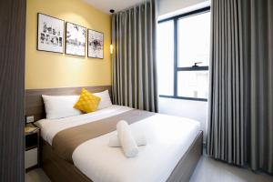 a hotel room with a bed and a window at Tony Apartment Soho Q1 in Ho Chi Minh City