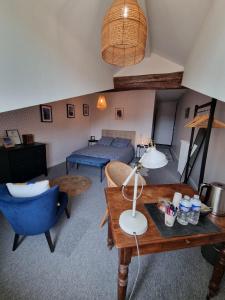 een woonkamer met een bed en een tafel bij La Maison VH in Mont-de-Marsan