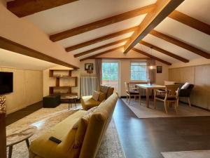 a living room with a couch and a table at Kaiser's Landhaus in Schliersee