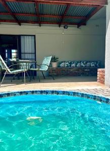 a swimming pool with a fish in the water at Lilibeth guesthouse in Parys
