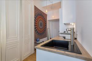 a kitchen with a sink and a counter top at Patchwork - Location meublé T2 - Lyon 2 in Lyon
