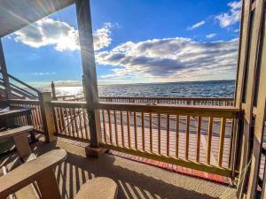 a balcony with a view of the beach and the ocean at Stunning 2BR/2BA Bayfront Retreat in Ocean City