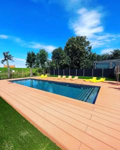a swimming pool on a wooden deck in a yard at Luxury Lake Lodge in Alphen