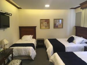 Postel nebo postele na pokoji v ubytování Hotel Florida