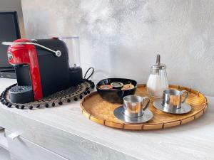 a table with a red blender and plates of food at Mansarda di charme con Vista in Turin