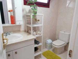 a bathroom with a white sink and a toilet at Balandros in Palm-Mar