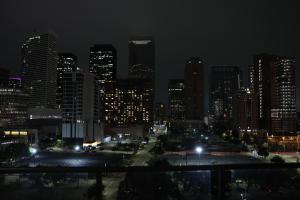 a view of a city at night with lights at Skyline Retreat Downtown HTX in Houston