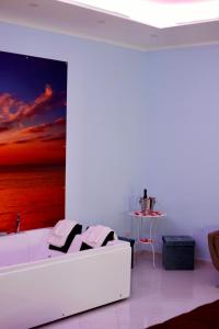 a white room with a bed and a painting on the wall at IN BLOOM ROOM b&b in Castel San Giorgio +71 photos