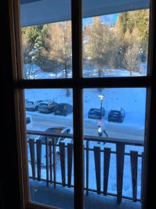 a view from a window of a parking lot at Cosy studio for 4 near ski lift, CRETES B24 in Les Collons