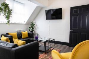 a living room with a couch and a table and a tv at Bootle, Liverpool Trendy 1Bed Ft in Liverpool