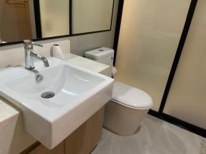 a bathroom with a sink and a toilet at The Chezz by Apple & Frank in Pattaya Central