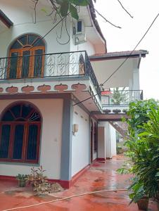 a house with a staircase and a balcony at Sobia Villa in Jaffna