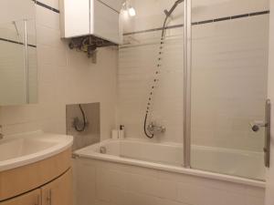 a bathroom with a shower and a tub and a sink at Elegant 2+1 BR Apt at Vienna's Vibrant 3. District in Vienna