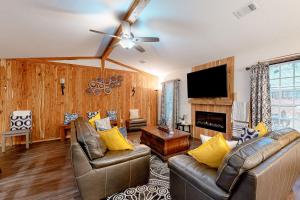 a living room with leather furniture and a flat screen tv at Roswell Radiance in Roswell