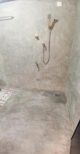 a shower with a hose in a bathroom at Venora Hiriketiya in Dickwella