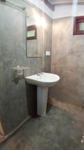 a bathroom with a sink and a mirror at Venora Hiriketiya in Dickwella