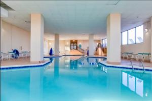 a swimming pool with blue water in a building at Marigot Beach 510 in Ocean City