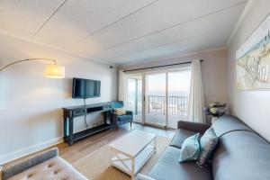 a living room with a couch and a tv at Marigot Beach 510 in Ocean City