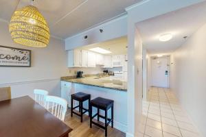 a kitchen and dining room with a table and chairs at Marigot Beach 510 in Ocean City
