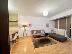 a living room with a couch and a table at Drd Pristine Apartment in Pristina