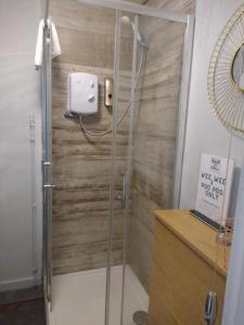 a shower with a glass door in a bathroom at The Crown Inn - By Whitney Inns in Keynsham