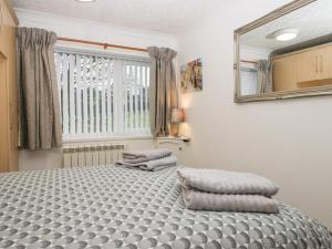 a bedroom with a bed with two pillows on it at Time and Tide in Carnforth